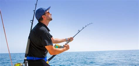 Fisherman Reeling In Catch Charter Fishing Pcb Fl Fishing Charters