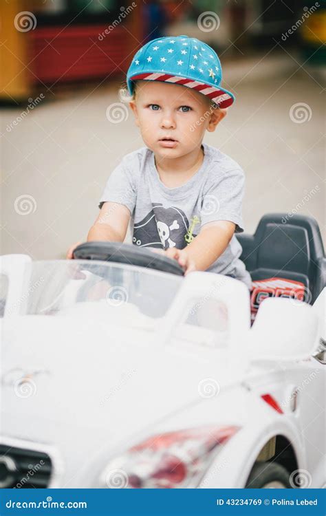 Fashion Little Boy Driving Toy Car In A Park Stock Photo Image 43234769
