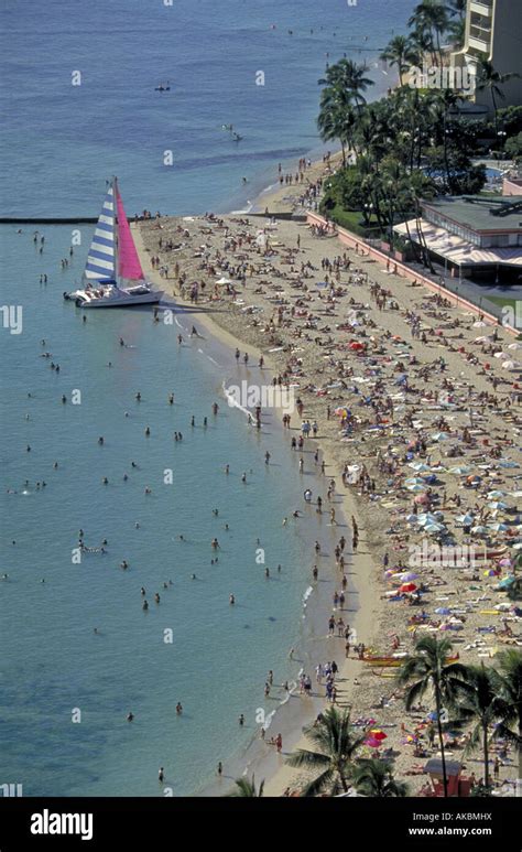 A Sailboat On A Very Crowded Waikiki Beach Near Honolulu Stock Photo