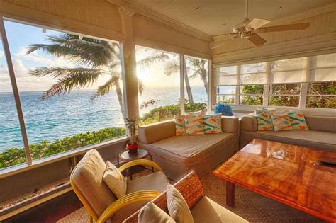 A Living Room Filled With Furniture Next To The Ocean