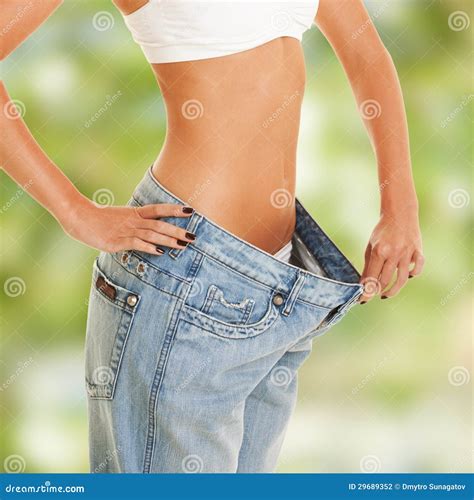 Woman Shows Weight Loss By Wearing An Old Jeans Stock Photo Image Of