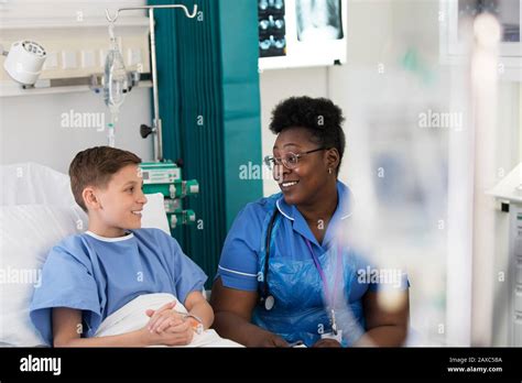 Female Nurse Talking With Boy Patient In Hospital Room Stock Photo Alamy