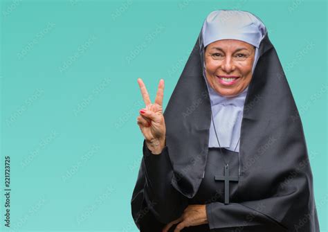 middle age senior christian catholic nun woman over isolated background smiling with happy face