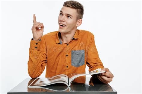 A Young Man Reads A Book The Guy Is Browsing The Magazine Reading