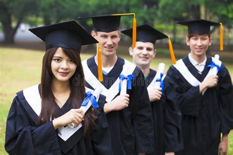 Students In Graduation Gowns On University Campus Stock Image Image