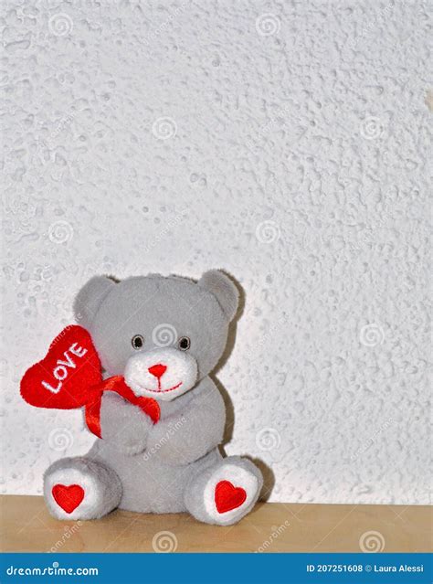 Sweet Cuddly Teddy Bear Holding A Heart With The Inscription Love A