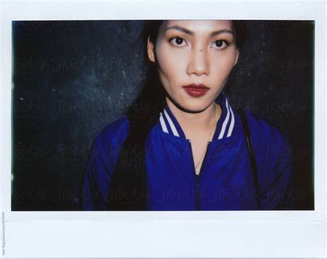 Instant Wide Polaroid Photo Of A Beautiful Asian Woman In Blue Bomber