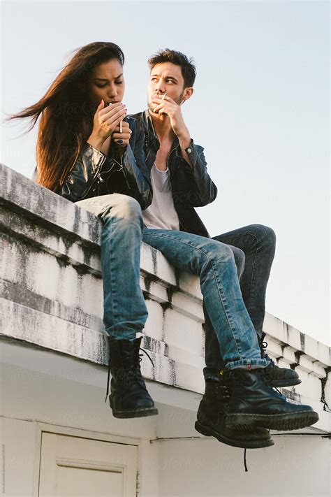 Couple Sitting On A Rooftop And Lighting Cigarette By Jovo Jovanovic Lifestyle Love