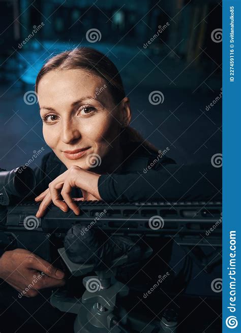 Contented Woman Sniper Posing For The Camera With Her Machine Gun Stock