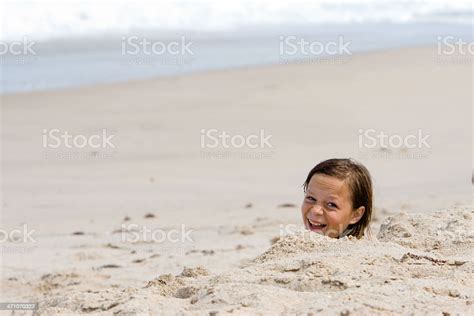 Girl Buried In Sand Stock Photo Download Image Now Beach Buried