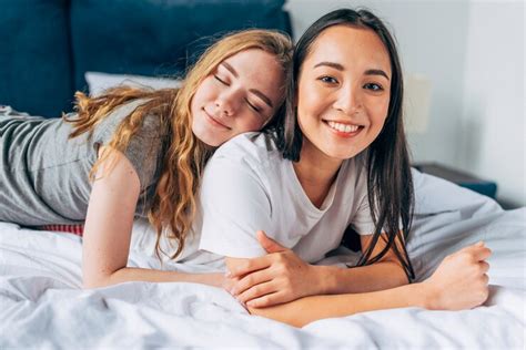 free photo lesbian couple lying on bed together