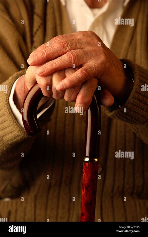 Old Man With Hands Leaning On Walking Stick Stock Photo Alamy