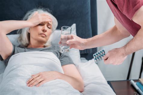 man giving glass of water and pills to sick wife stock image image of healthcare sick 98423877