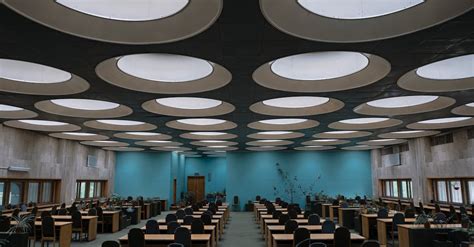 Interior Of Modern Library With Geometric Ceiling And Wooden Furniture