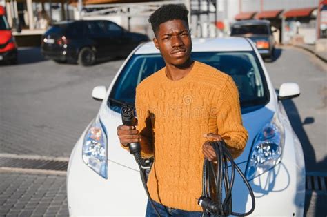 African American Man Charging His Electric Car Stock Image Image Of