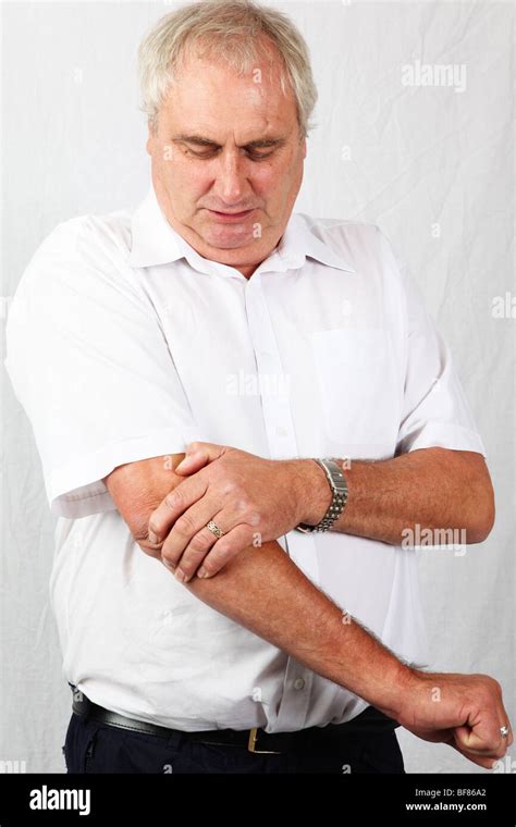 50s 60s Mature Grey Man Holding Painful Elbow Suffering From