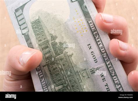 Hand Holding Banknote Bundle Of US Dollar On A Linen Canvas Background Stock Photo Alamy