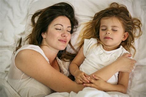 Mother And Daughter Sleeping Together In Bed Mother And Daughter Embracing In Bed Asleep Stock