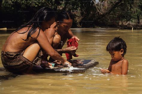 Key to propel sarawak's economy 2. Indigenous Dayak, washing in river, tropical rainforest ...
