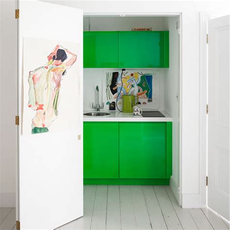 Pale green / grey colour painted units and white worktops ( not corian but similar material) shaker style. Ways to add colour to an all white kitchen