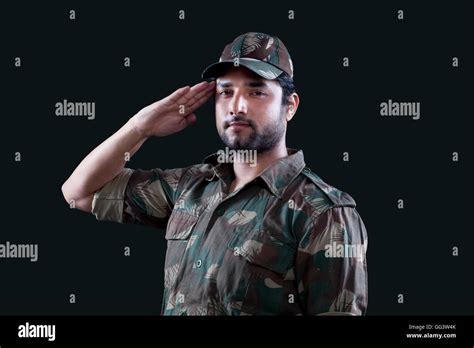 Portrait Of Young Male Soldier Saluting Stock Photo Alamy