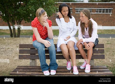 Girls Talking On Bench Stock Photo Alamy