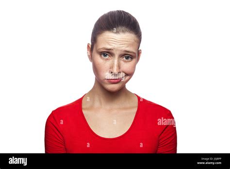 Portrait Of Sad Unhappy Woman In Red T Shirt With Freckles Studio Shot