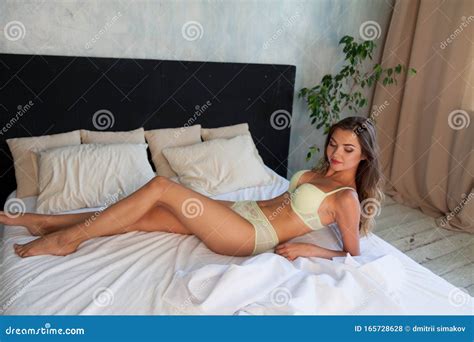Portrait Of A Beautiful Fashionable Woman In Lingerie In The Bedroom On