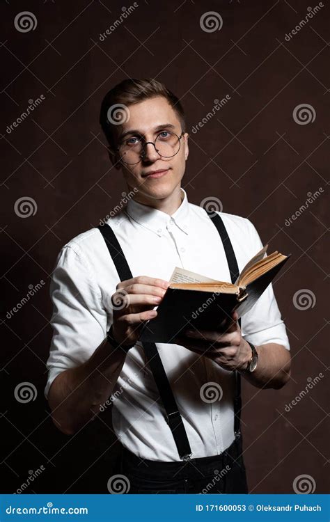 A Man In Round Glasses Suspenders A White Shirt Is Reading A Book Stock Image Image Of