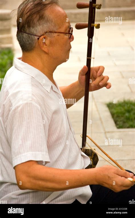 Old Chinese Musician Practicing In The Early Morning Stock Photo Alamy