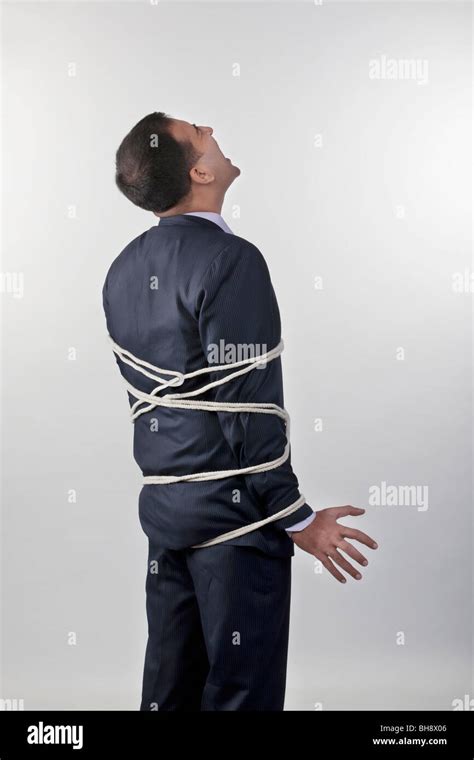 Businessman Tied Up With Rope Stock Photo Alamy