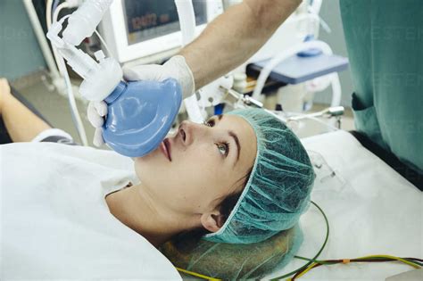 Patient On Operating Table Being Given An Anesthetic Mask Stock Photo