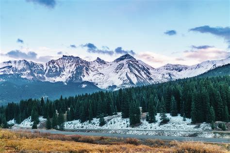 Snow Capped Rocky Mountains And Ever Green Forest In Colorado