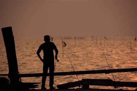 Premium Photo The Fisherman Silhouette With Sunset Sky