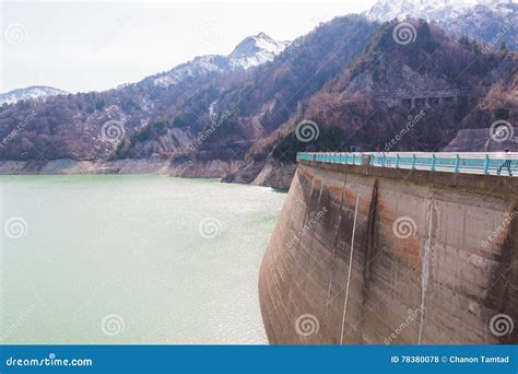 Dam Between Mountains With Green Lake At Kurobe Dam Japan Stock Photo
