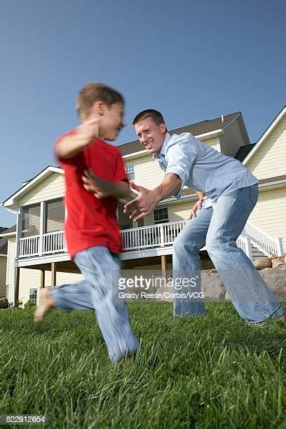 Young Father Run Chasing Son At Home Photos And Premium High Res