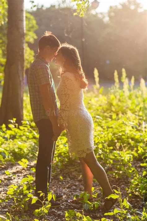 Closeup Photo Of Romantic Kissing Couple Outdoors Side View Stock