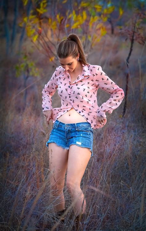 Royalty Free Photo Woman Wearing Pink Dress Shirt And Blue Denim Cut Off Shorts Standing On