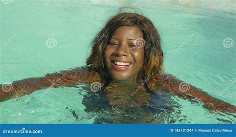 happy and beautiful black afro american woman in bikini having fun at tropical beach resort