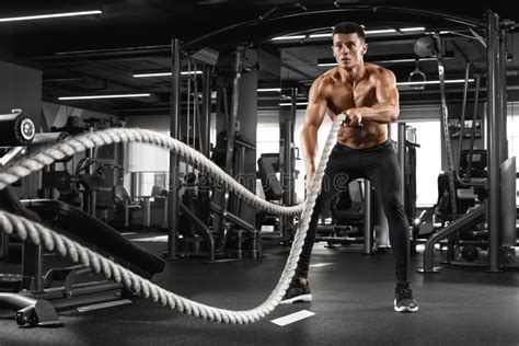 Muscular Man Working Out With Heavy Ropes In Gym Strong Male Naked Torso Abs Stock Image