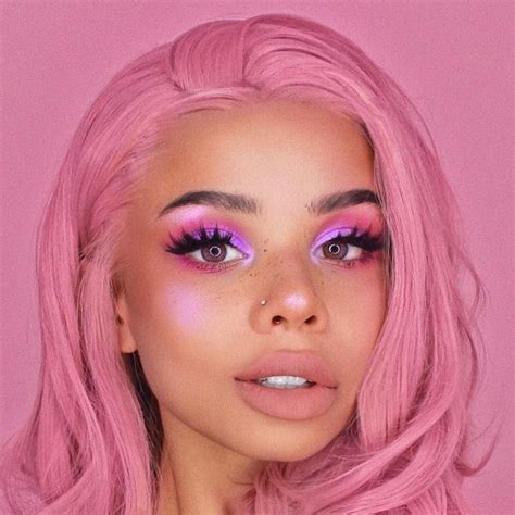 Bubblegum Pink Hair On Girl With Bronze Skin Wearing Eyeshadow In Different Shades Of Pink