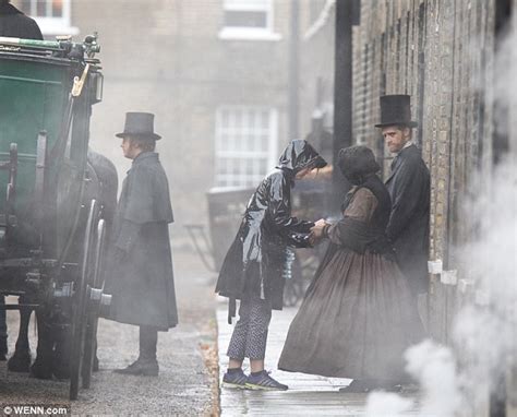 Felicity Jones Shelters From The Rain As She Marches Along In Victorian Gown On The Aeronauts