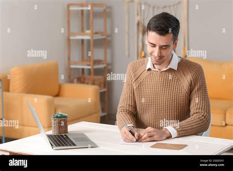 Young Man Writing Letter At Home Stock Photo Alamy