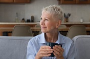 Happy Older Woman Relaxing Seated on Couch with Mug Stock Photo - Image ...