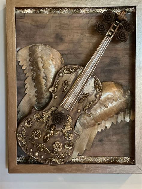 A Wooden Frame With An Intricately Carved Guitar In The Center And
