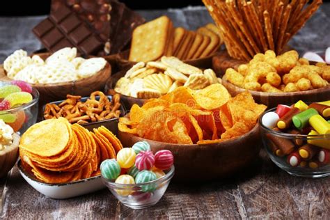 Salty Snacks Pretzels Chips Crackers In Wooden Bowls On Table Stock