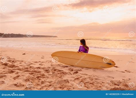 Surfer Girl With Surfboard On A Beach At Sunset Stock Image Image Of