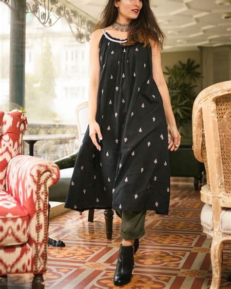 Green square neck polka dot print puff sleeve mini dress. Black floral spaghetti dress by Threeness | The Secret Label