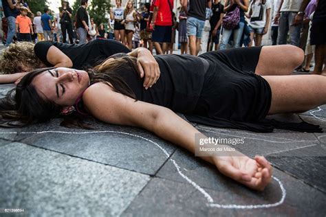 Women Lay On The Floor As If They Were Dead During A Performance