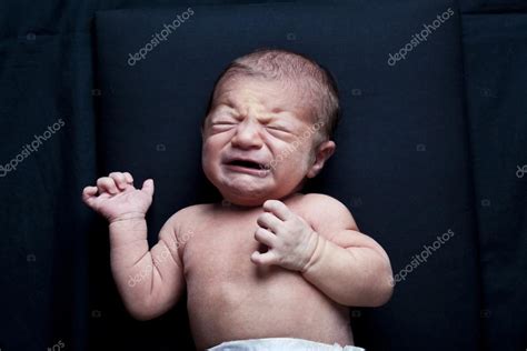 Portrait Of Adorable Newborn Baby Girl Crying On Black Background